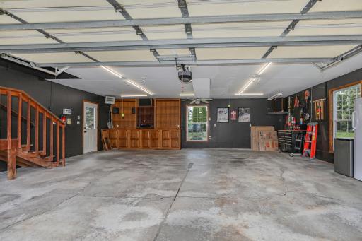More than just a place to park! This premium, heated and insulated finished garage features a convenient floor drain, bright LED workshop lighting, and built-in cabinetry and entertainment setup.