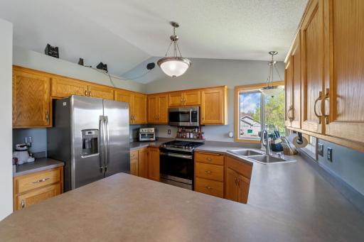 Kitchen showcases newer stainless steel appliances. The corner window brings in so much natural light