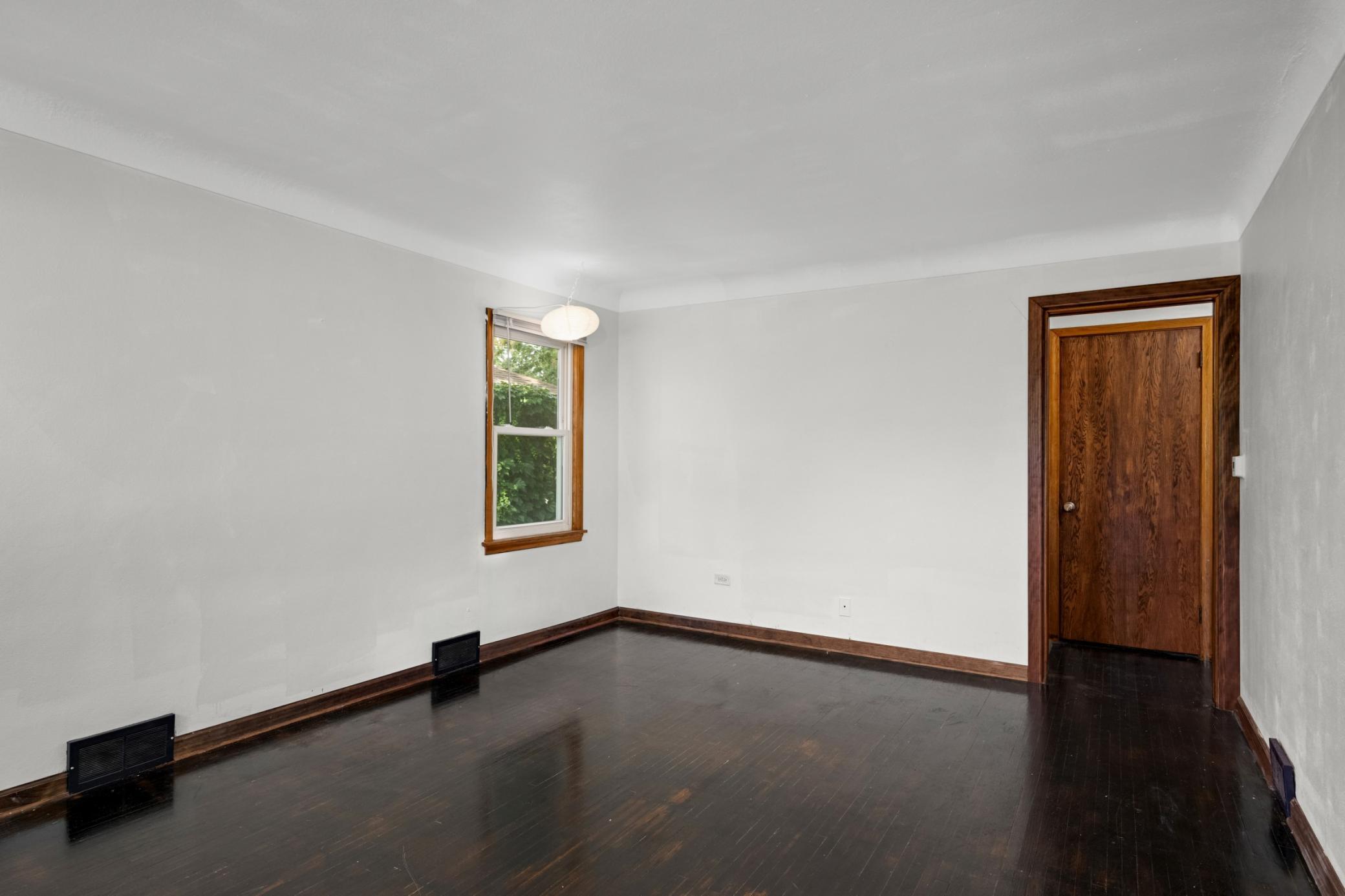Classic hardwood with fresh, neutral walls and newer windows
