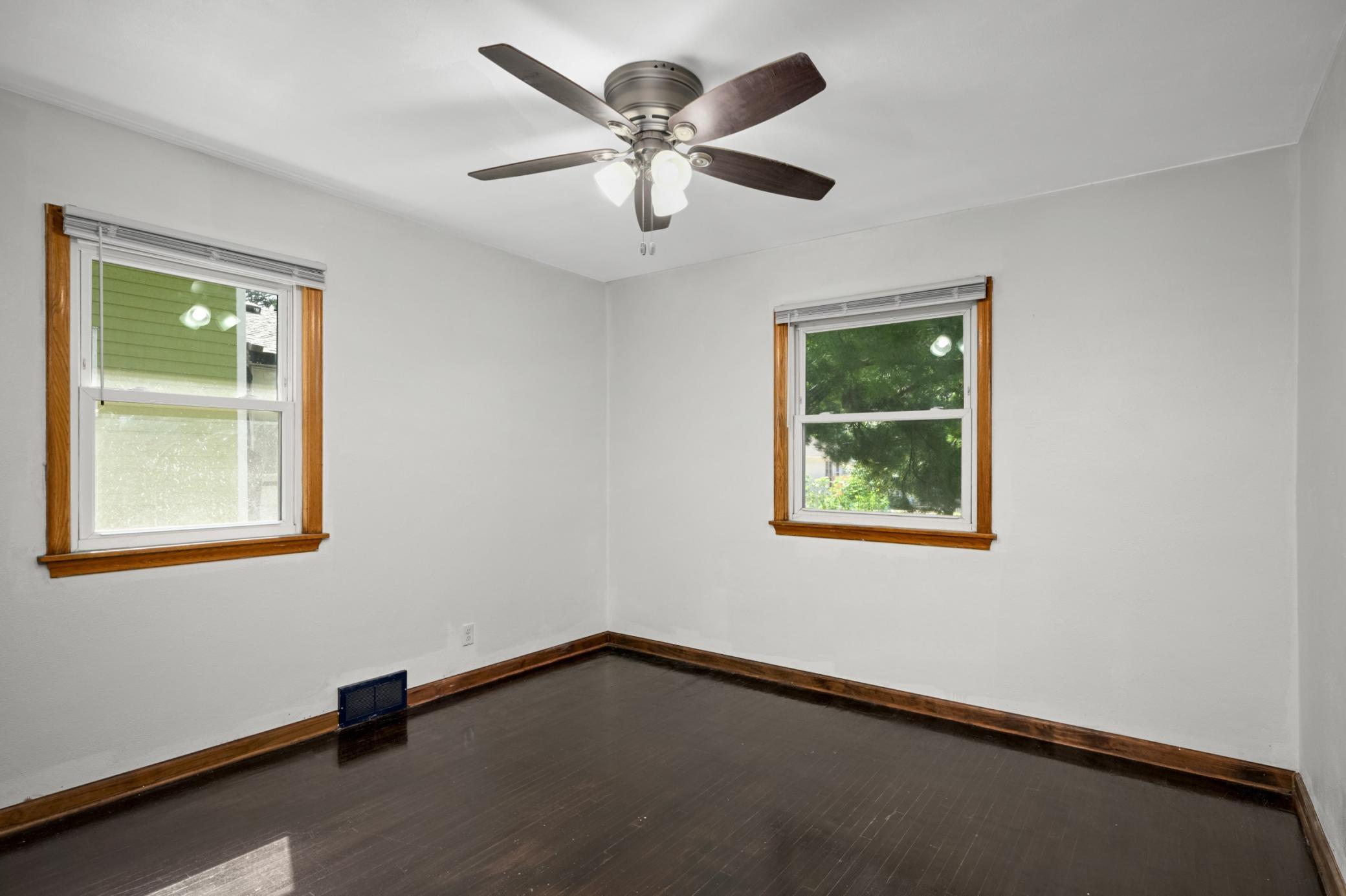 Multiple bedroom windows provide natural light