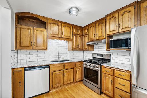 Subway tile, stone counter tops, gorgeous cabinets, stainless appliances, wood floors. Check, check, check!