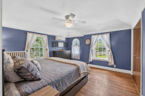 Large primary bedroom filled with natural light