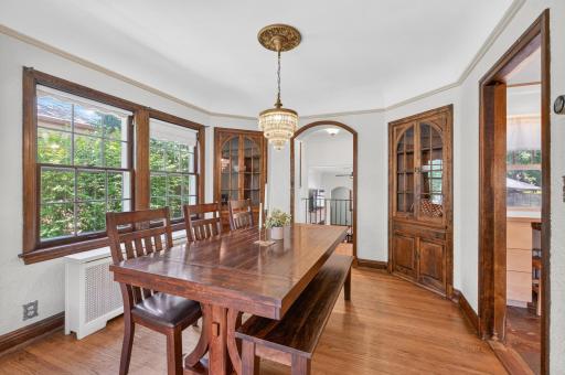 Spacious dining room featuring lovely built-ins and an elegant vintage chandelier
