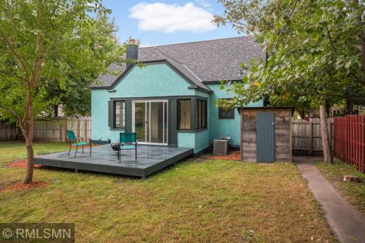 Sidewalk area house to garage service door with a firepit and plenty of room for a garden, pets or entertainment