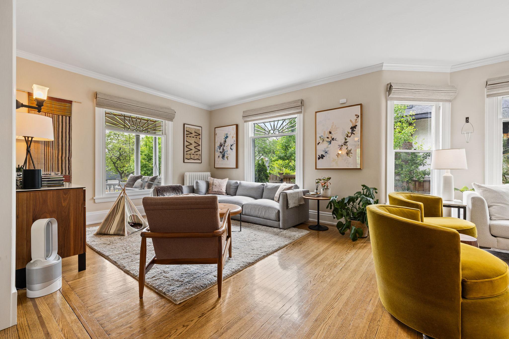 Living room with multiple seating areas.