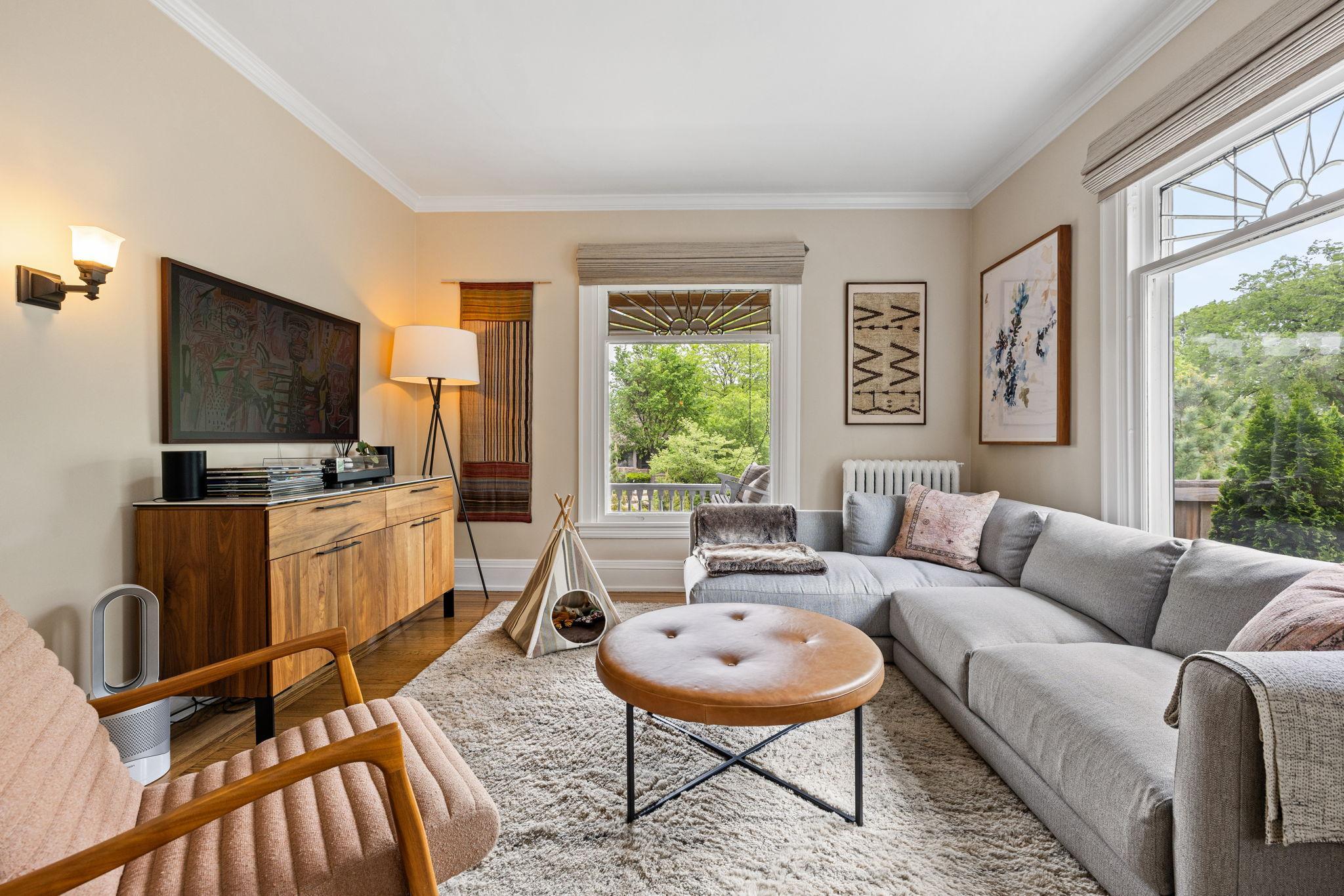 The living room features leaded windows.