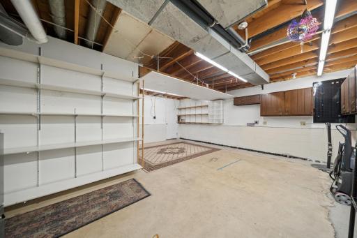 Unfinished lower level room with walk out door to backyard