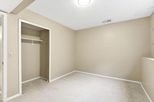 The second lower level BR showing the open "no doors" closet.