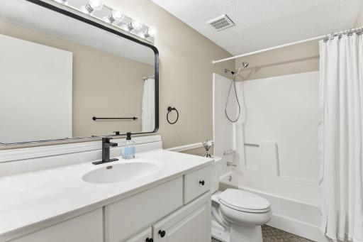 And the very nice FULL lower level bath. Freshly Painted- nicely updated. Even a NEW SHOWERHEAD!
