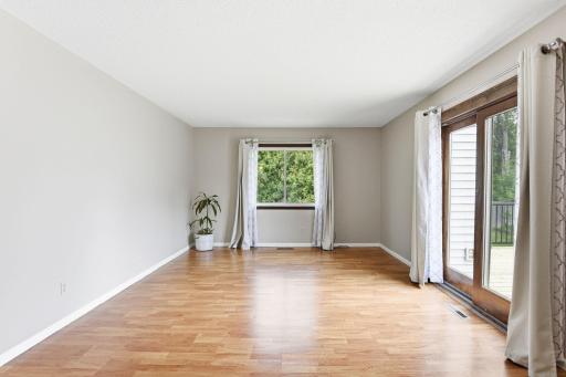 Spacious living/dining room walks out to fabulous deck. Such a Bright happy space.