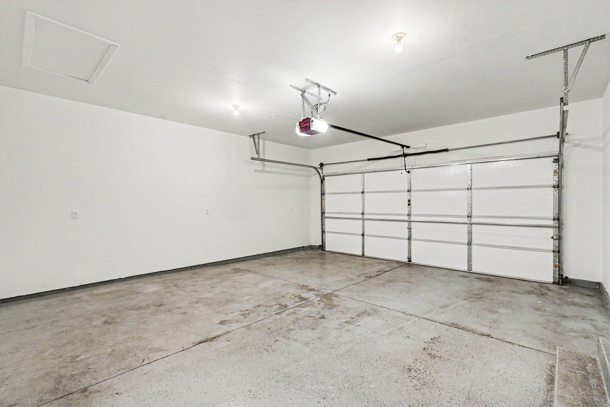 Fully sheetrocked garage with insulated walls and garage doors.