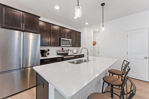 Beautiful kitchen with quartz countertops, and stainless steel appliances