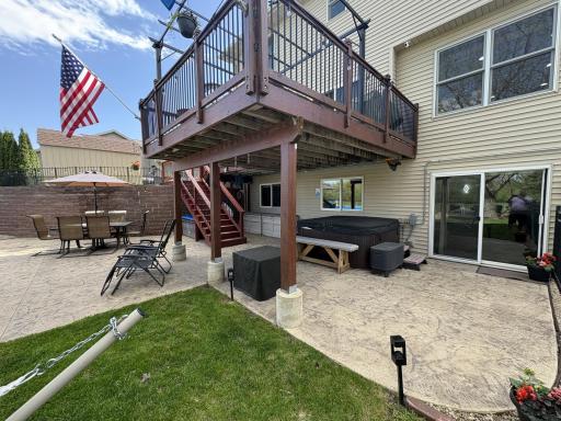 As you see 2 accesses to your back yard fun, one from deck/dining room area and the 2nd from the lower level great room. The stamped concrete runs throughout this area of the back yard.