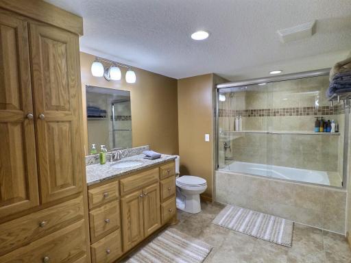 The lower level full bath with surround tile shower/tub.