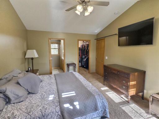 Another view of the primary bedroom showing the walk in closet and private bath.