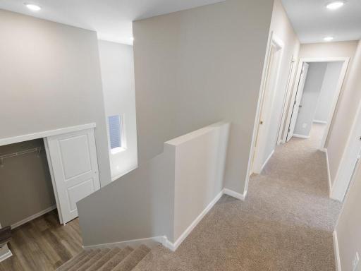 Main Level Landing. Photo taken of another home with similar plan and finishes. Photos and renderings may not depict actual plan, materials, & finishes may vary. All measurements are approximate.