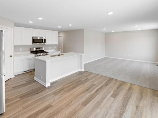 Open Concept. Photo taken of another home with similar plan and finishes. Photos and renderings may not depict actual plan, materials, & finishes may vary. All measurements are approximate.