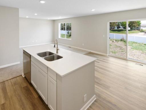 Open Concept. Photo taken of another home with similar plan and finishes. Photos and renderings may not depict actual plan, materials, & finishes may vary. All measurements are approximate.