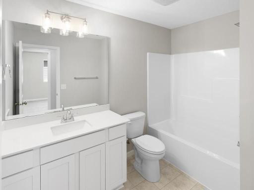 Hall Bathroom. Photo taken of another home with similar plan and finishes. Photos and renderings may not depict actual plan, materials, & finishes may vary. All measurements are approximate.