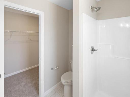 Primary Bath. Photo taken of another home with similar plan and finishes. Photos and renderings may not depict actual plan, materials, & finishes may vary. All measurements are approximate.