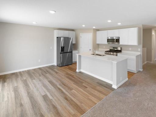 Kitchen & Dining. Photo taken of another home with similar plan and finishes. Photos and renderings may not depict actual plan, materials, & finishes may vary. All measurements are approximate.
