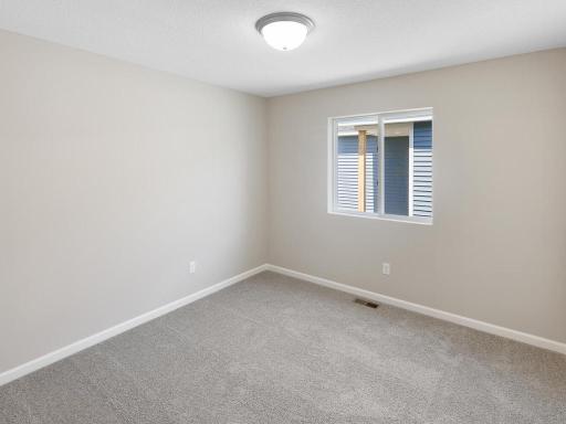 Bedroom 3. Photo taken of another home with similar plan and finishes. Photos and renderings may not depict actual plan, materials, & finishes may vary. All measurements are approximate.