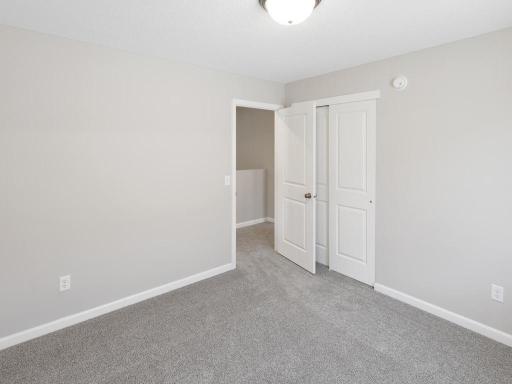 Bedroom 2. Photo taken of another home with similar plan and finishes. Photos and renderings may not depict actual plan, materials, & finishes may vary. All measurements are approximate.