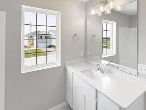 Primary Bath. Photo taken of another home with similar plan and finishes. Photos and renderings may not depict actual plan, materials, & finishes may vary. All measurements are approximate.