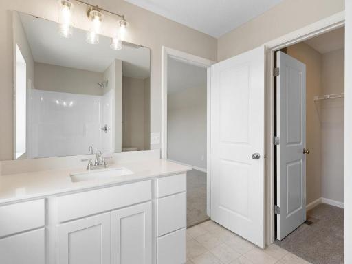 Primary Bath. Photo taken of another home with similar plan and finishes. Photos and renderings may not depict actual plan, materials, & finishes may vary. All measurements are approximate.