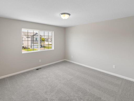 Primary Suite. Photo taken of another home with similar plan and finishes. Photos and renderings may not depict actual plan, materials, & finishes may vary. All measurements are approximate.