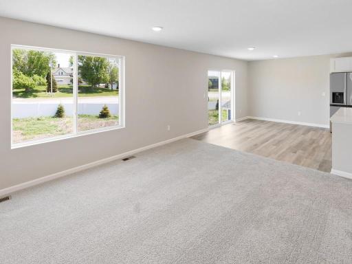 Living Room & Dining. Photo taken of another home with similar plan and finishes. Photos and renderings may not depict actual plan, materials, & finishes may vary. All measurements are approximate.