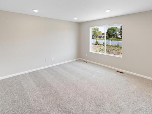 Living Room. Photo taken of another home with similar plan and finishes. Photos and renderings may not depict actual plan, materials, & finishes may vary. All measurements are approximate.