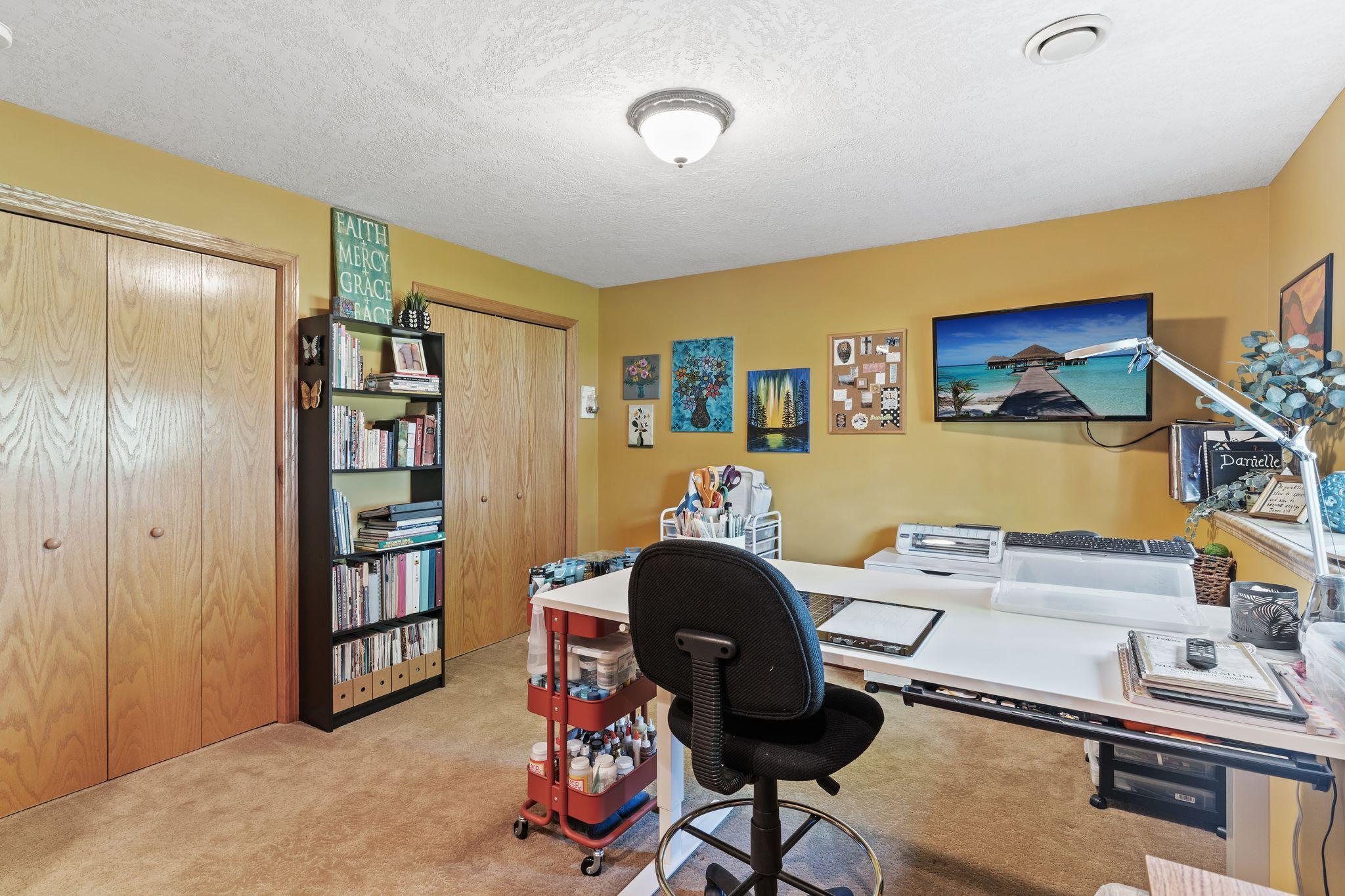 4th bedroom in basement, currently being used as a craft space.