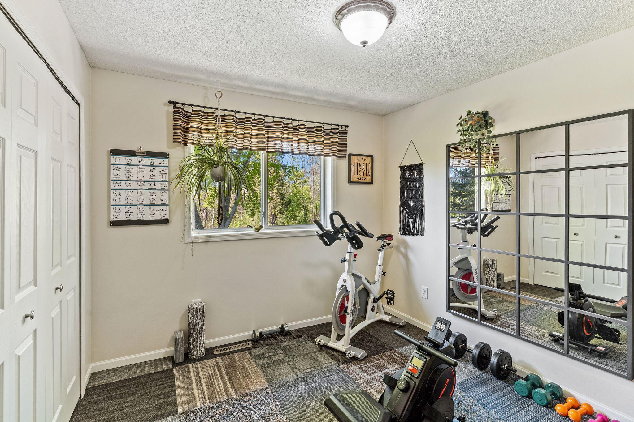 3rd bedroom on the main floor, currently being used as an exercise room.