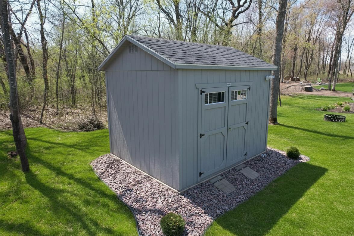 The shed has electrical service and offers ample space to store a riding lawn mower along with other lawn equipment and tools.
