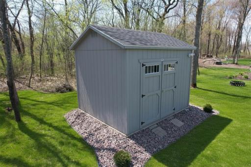The shed has electrical service and offers ample space to store a riding lawn mower along with other lawn equipment and tools.
