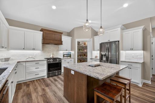 Spacious walk-in pantry offering ample storage and easy organizationâperfectly designed to support a well-appointed kitchen.