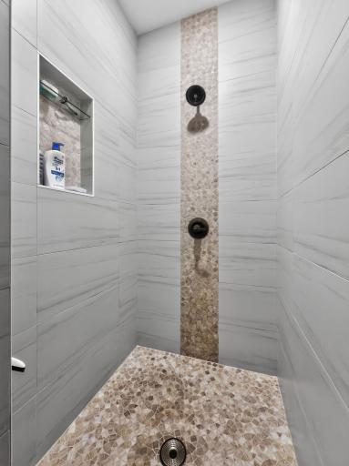 Massive tiled walk-in showerâoffering a sleek, spa-like retreat with ample space and modern design.
