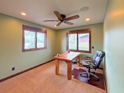 The second main-level bedroom is thoughtfully designed with double windows and a ceiling fan to maximize cooling summer breezes from the lake.