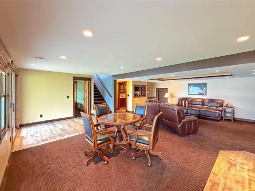 The spacious lower-level living area is perfect for relaxing by the fire or hosting guests in comfort and style.