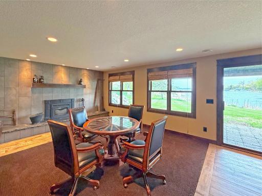 Inviting family room with a wood-burning fireplace and picturesque views of the lake. Enjoy direct walkout access to the lake.