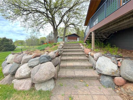 Beautifully landscaped stairs lead to the main level and a convenient side entrance to the deck and home.