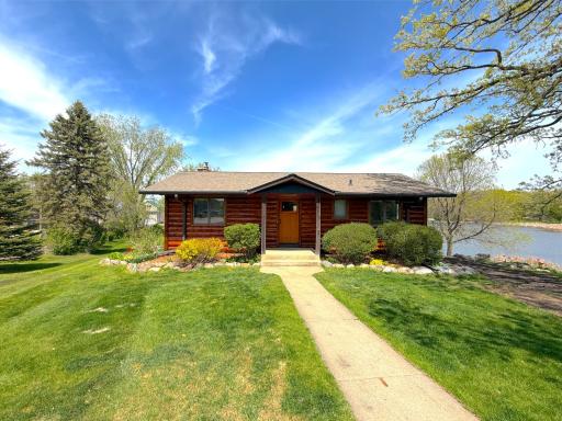 Covered porch, stacked stone and stunning mature landscaping with every corner you turn welcome you home.