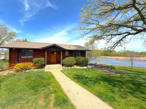 The property is surrounded by mature trees and thoughtfully placed perennials, enhancing its natural beauty and privacy.