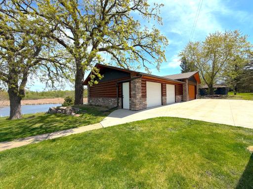 A large concrete driveway leads to a walkway that welcomes you to the front entrance of the home.