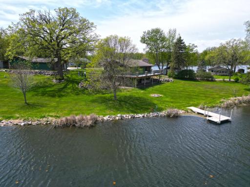 The property is thoughtfully surrounded by boulder landscaping, creating a natural and visually striking setting.