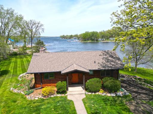 The exteriorâs hand-hewn half-log siding adds rustic charm and a true lakeside feel.