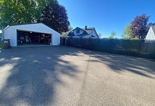 Oversized 2+ car garage with additional parking pad