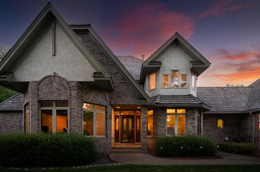 Front entry/ door enhanced by transom above door, sidelights on each side plus window in door catching the morning sunrises