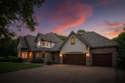 This stately home sits with-in a cul-de-sac on this private wooded lot
